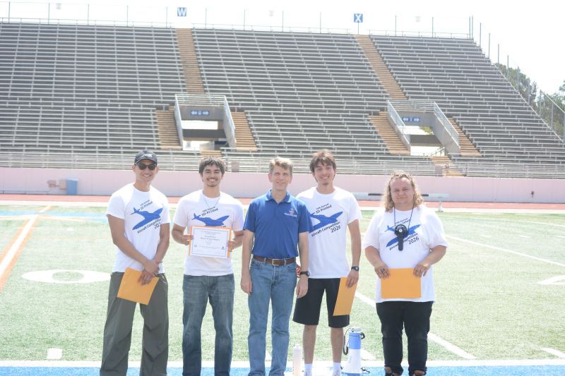 Winning teams poses with award