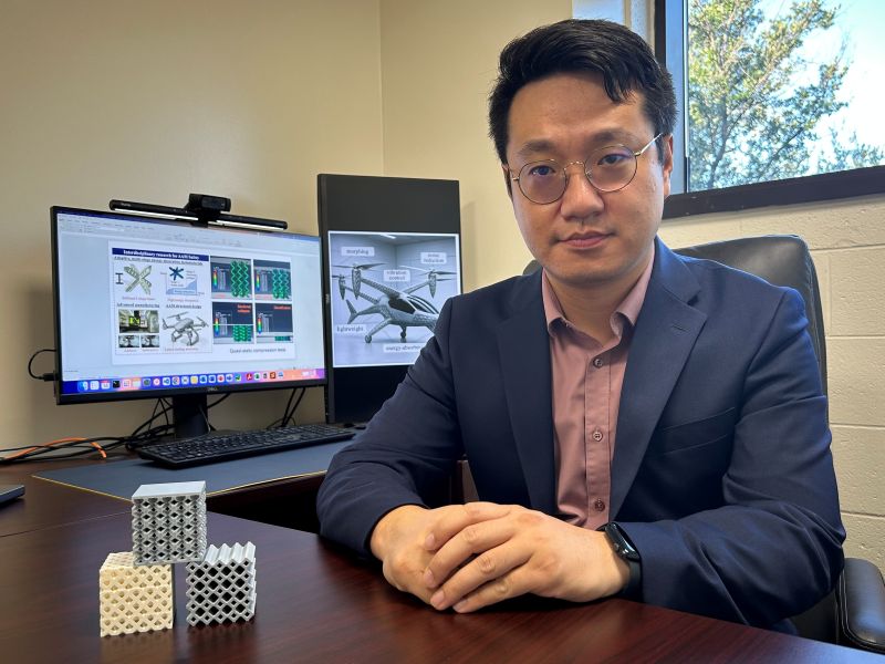 Professor Liu at his desk with research