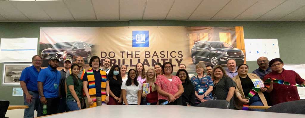 Cindy Cruz-Rodriguez with her co-workers at GM