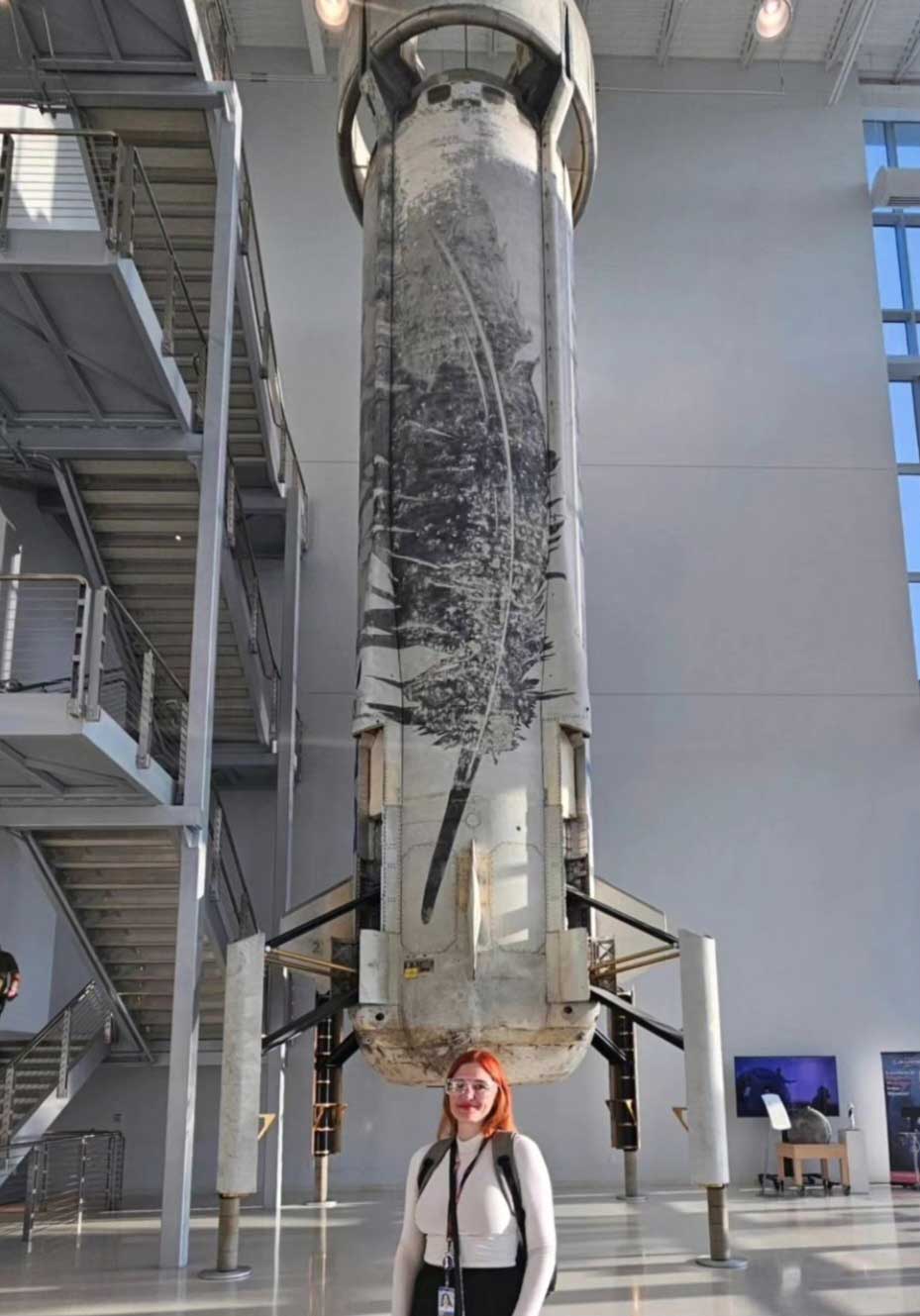 Erin McNeil in front of a rocket