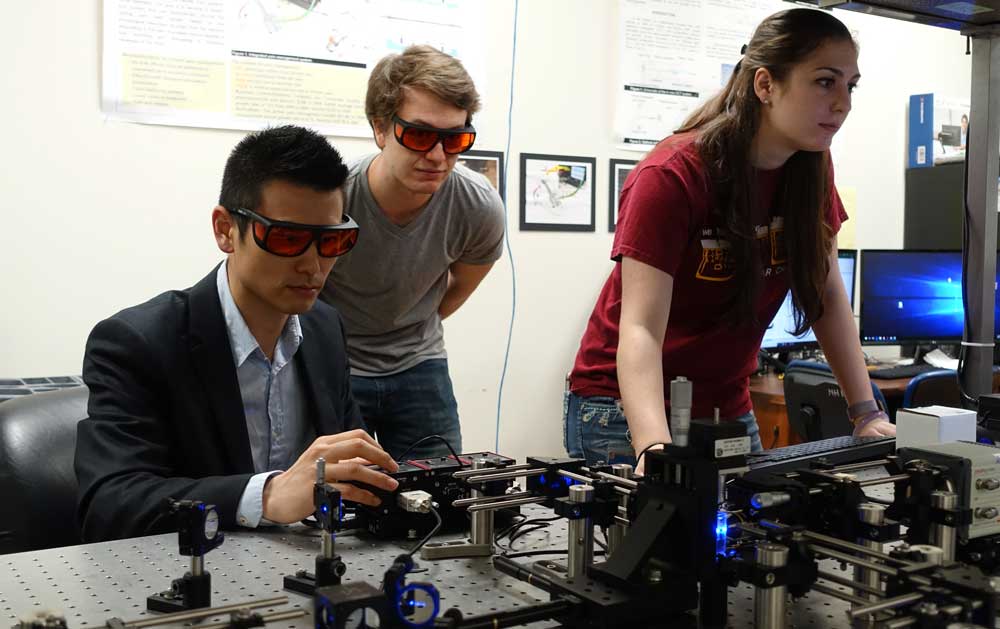 A Professor and Two Students in a lab.