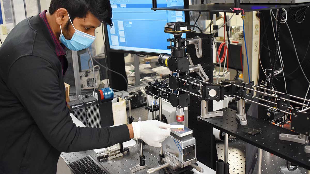 Photonics researcher in a lab