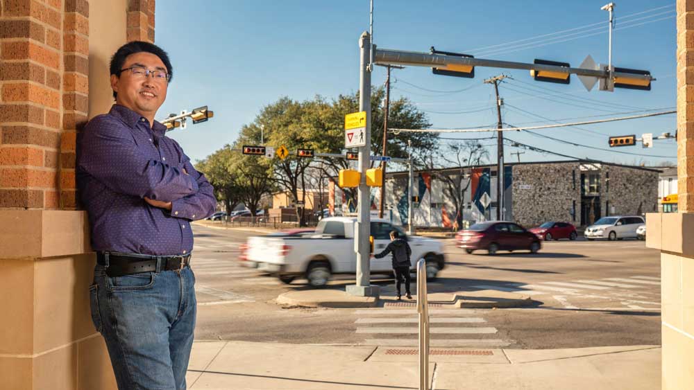 Professor in front of traffic signal in an intersection