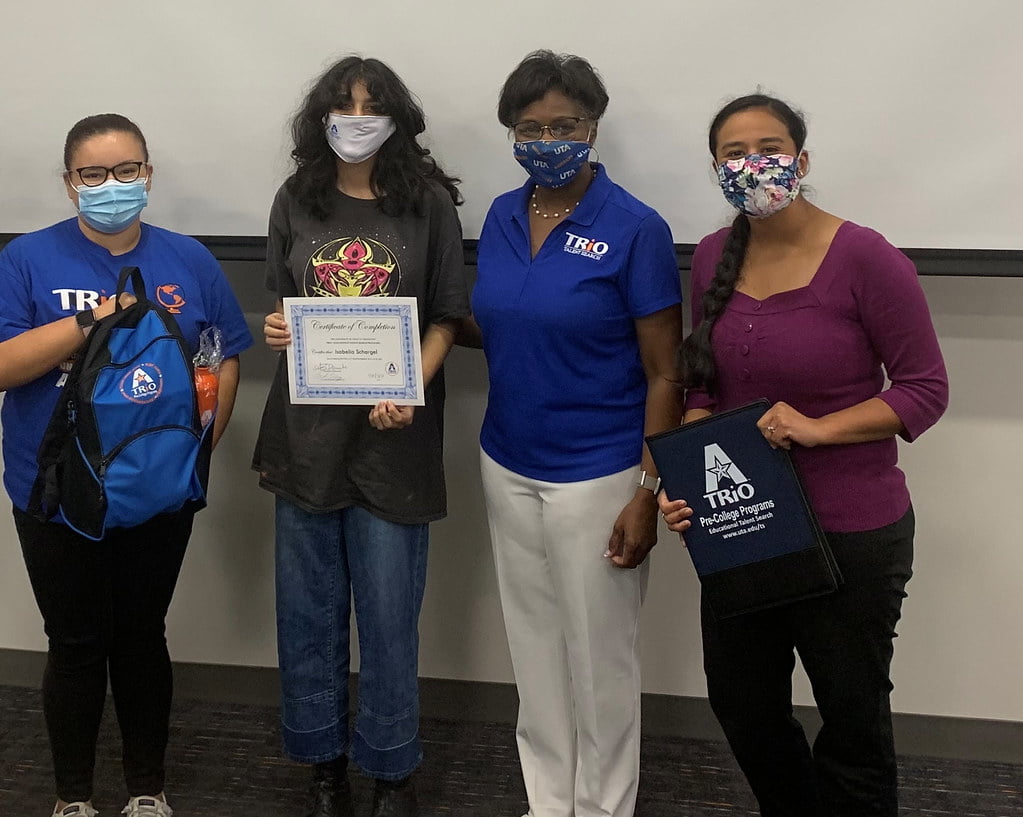 group of students and a group of staff together taking a picture