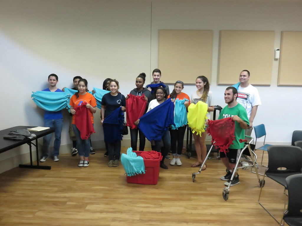 a group of students holding blankets