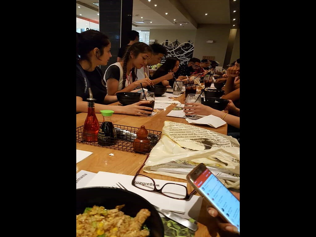 group of students eating in a restaurant