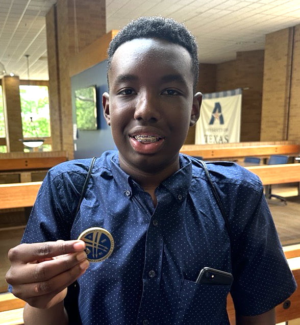 Teenager holding coin