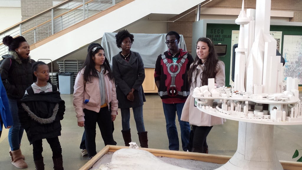 group of students looking at a architecture building model