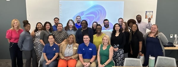 group of people sitting and standing in chairs
