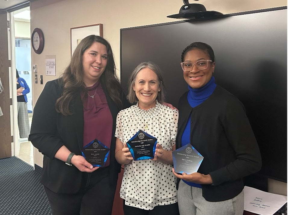 group of three women holding awards