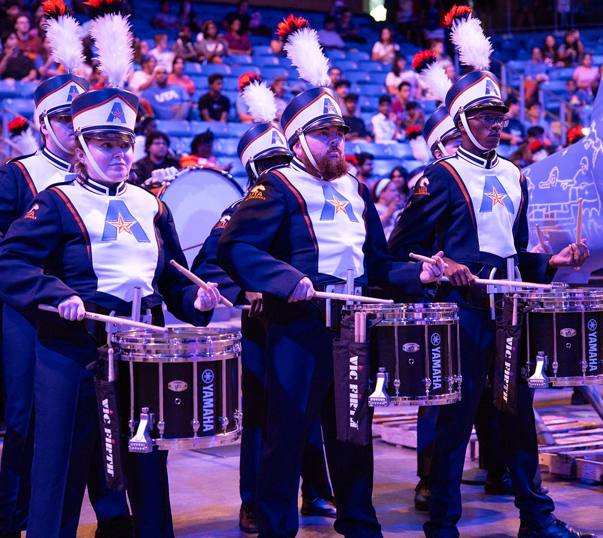 marching band drummers performing at uta mavs meet event