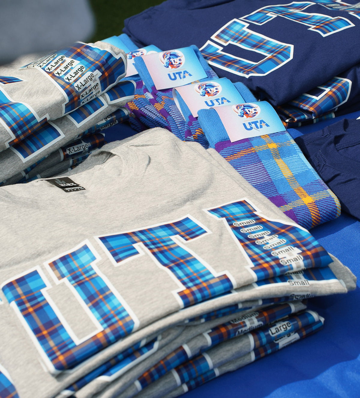 shirts and socks with the uta 130 anniversary tartan pattern