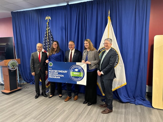 President Cowley accepting postsecondary success recognition program award