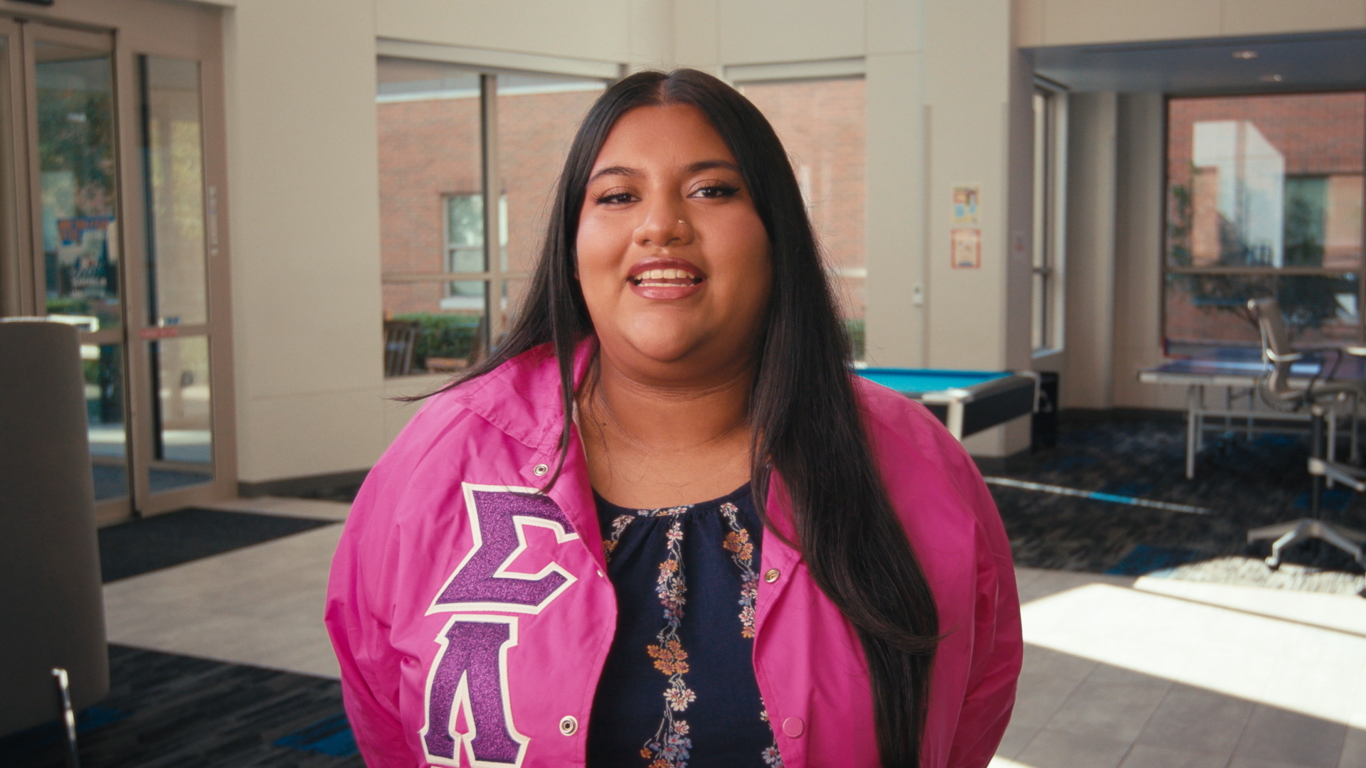 A photo of a woman in a pink jacket