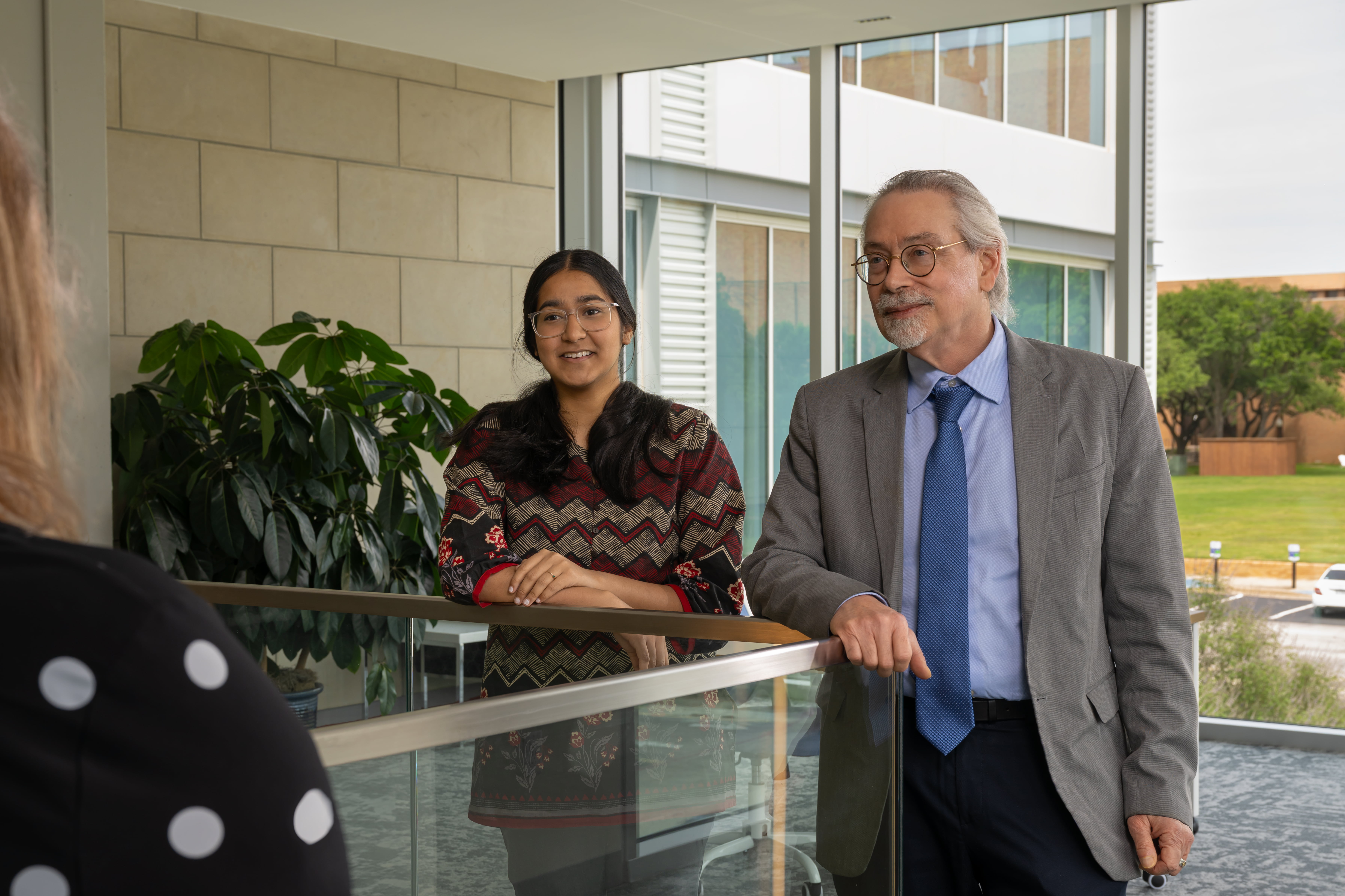 Dr. James Grover and UTA Student Faizah Kahn listening to host