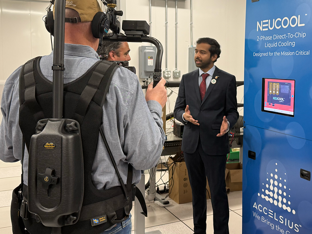Man in suit explains machine to media