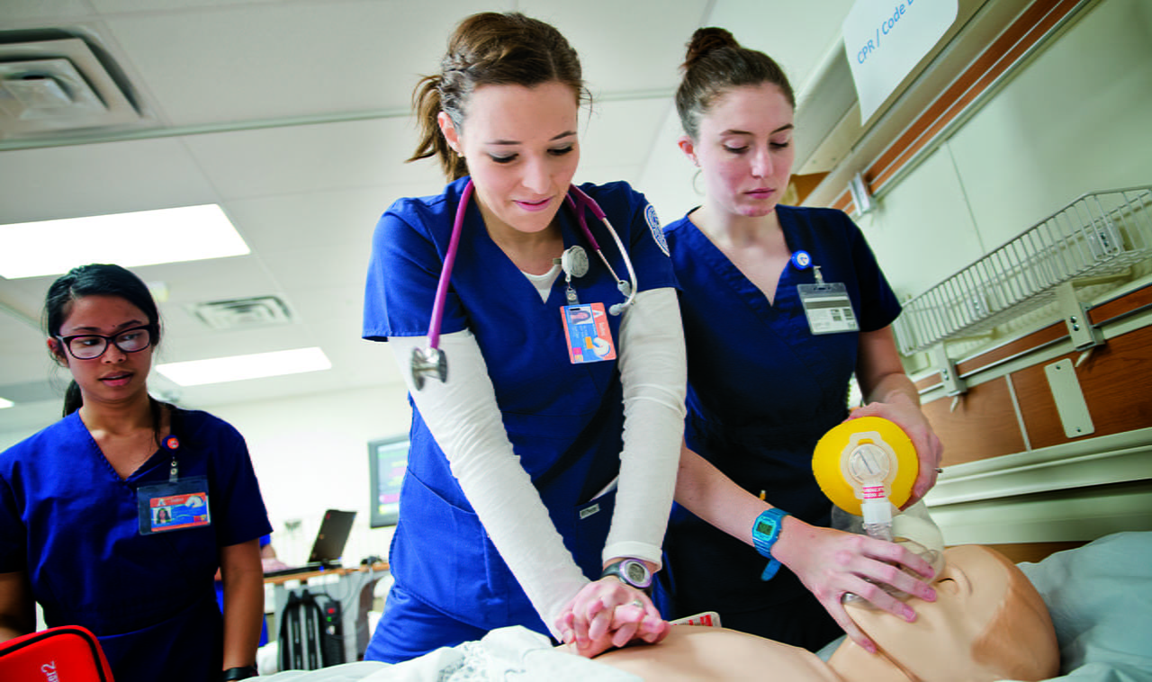 Students in the College of Nursing and Health Innovation at UTA practicing CPR