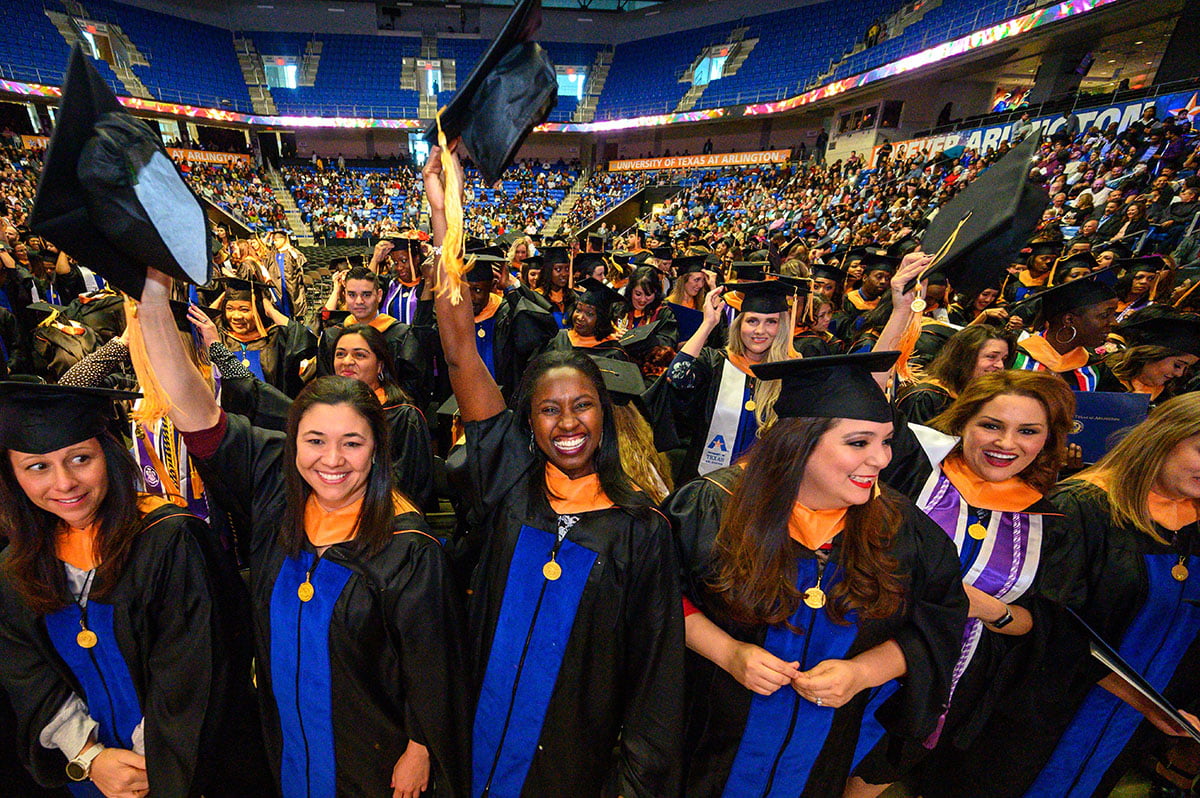 nursing graduates tossing the cap at commencement