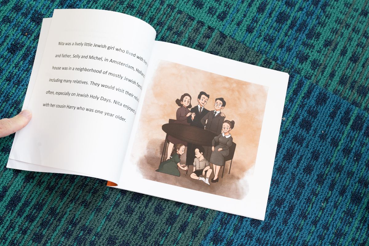 A children's book lay open on the floor of a library" _languageinserted="true