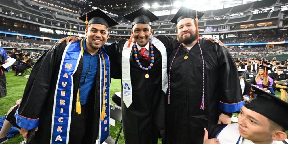 UTA graduates pose for photo on field at Globe Life Field" _languageinserted="true