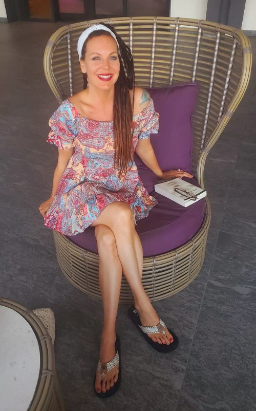 Seraphina Nova Glass sitting on a chair