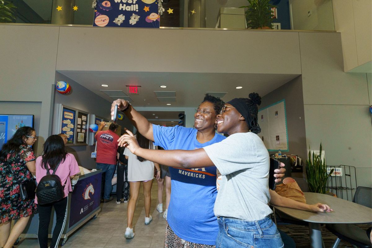 A family taking a selfie inside West Hall on move in day 