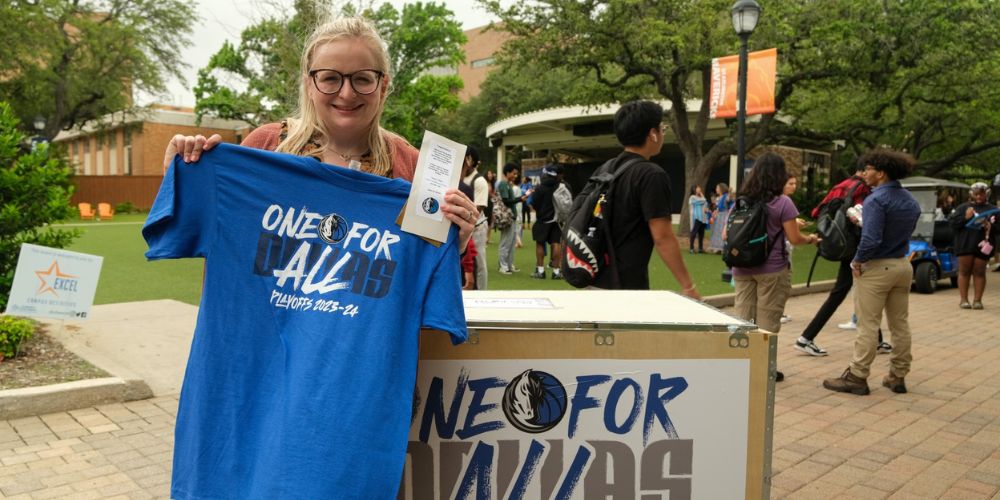 Danielle Beach holding tshirt and mavs tickets