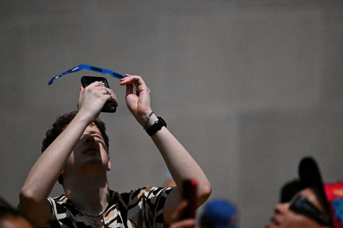 Member of UTA community takes photo of solar eclipse using phone" src="/https://cdn.prod.web.uta.edu/-/media/project/website/news/releases/2024/04/solar-eclipse-person-glasses-phone.jpg?la=en" _languageinserted="true