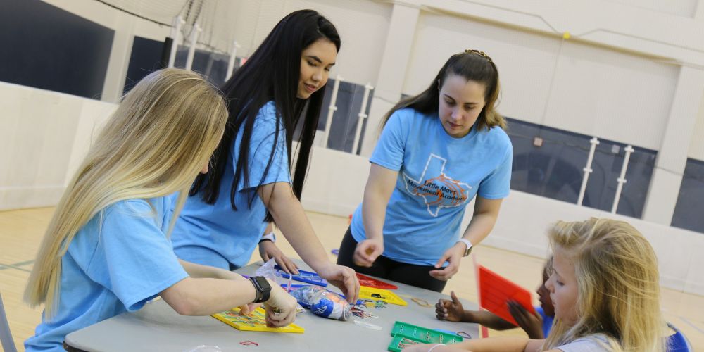 Photo of Little Mavs participants and volunteers interacting in an activity." _languageinserted="true