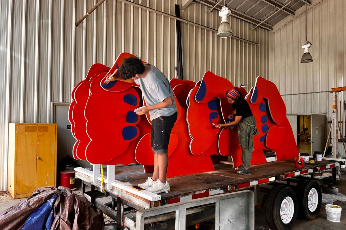 Students painting COLA float