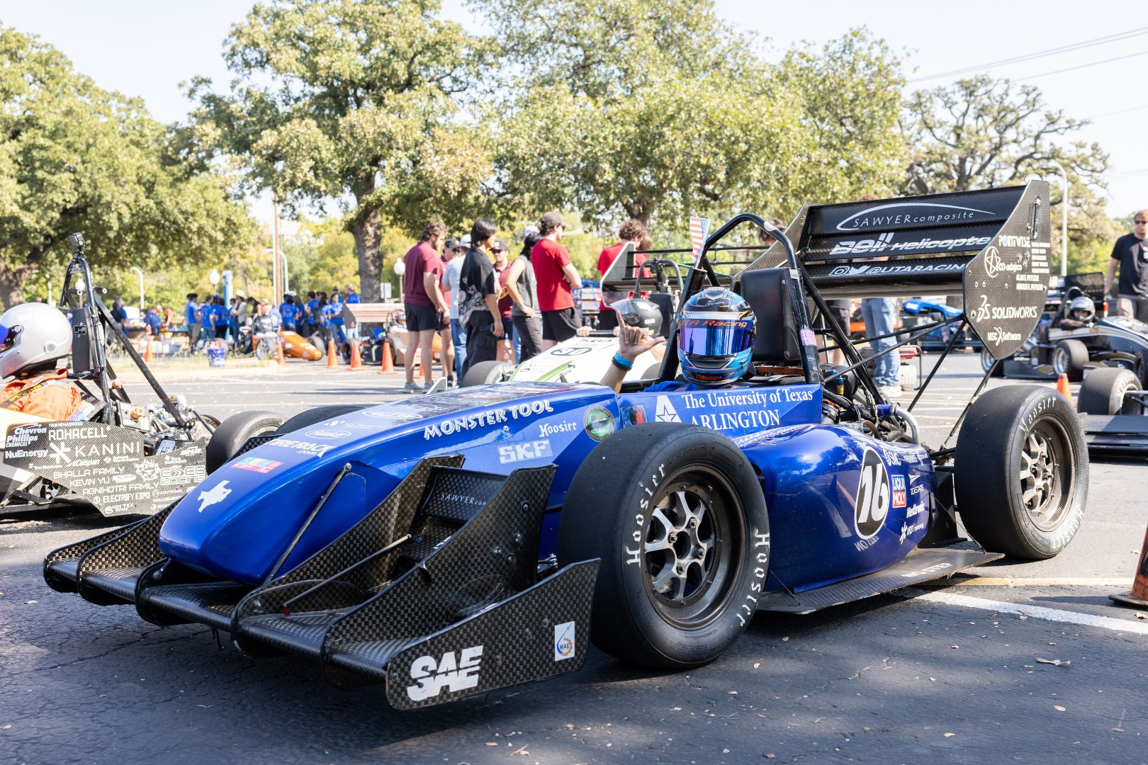 Image of a UTA Racing member in the cockpit of a formula race car 