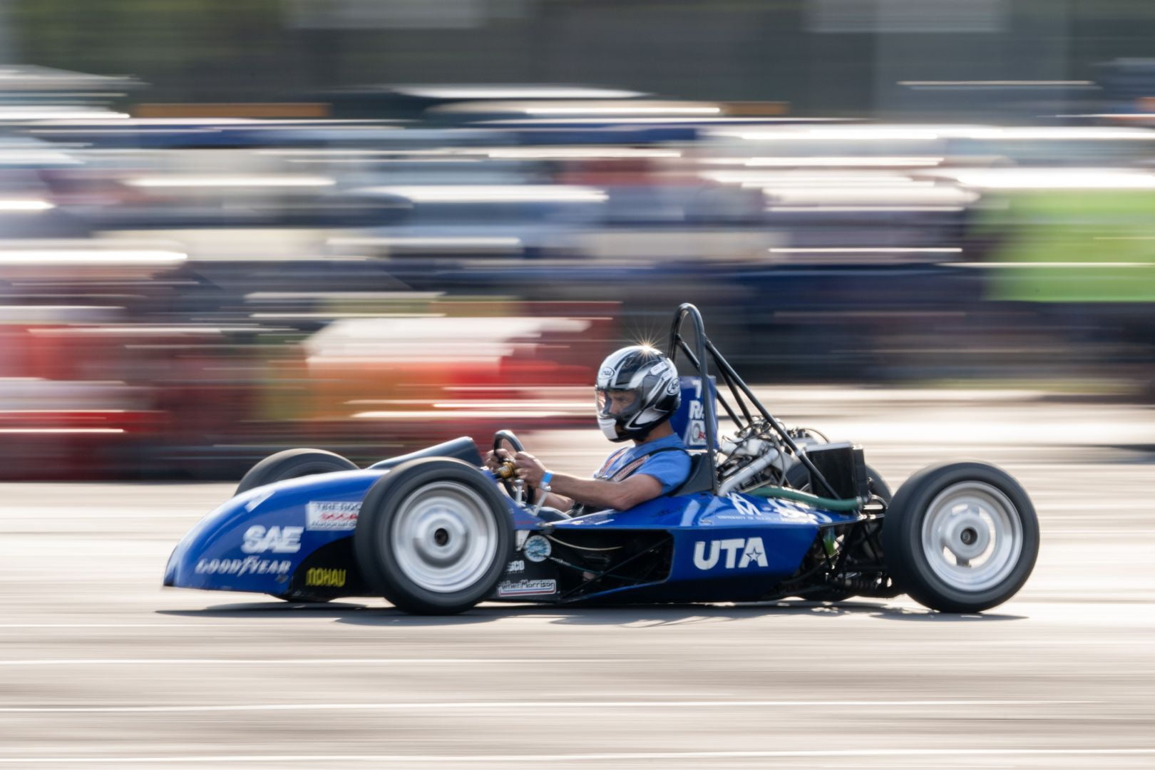 Image shows a UTA Racing member driving a UTA formula car