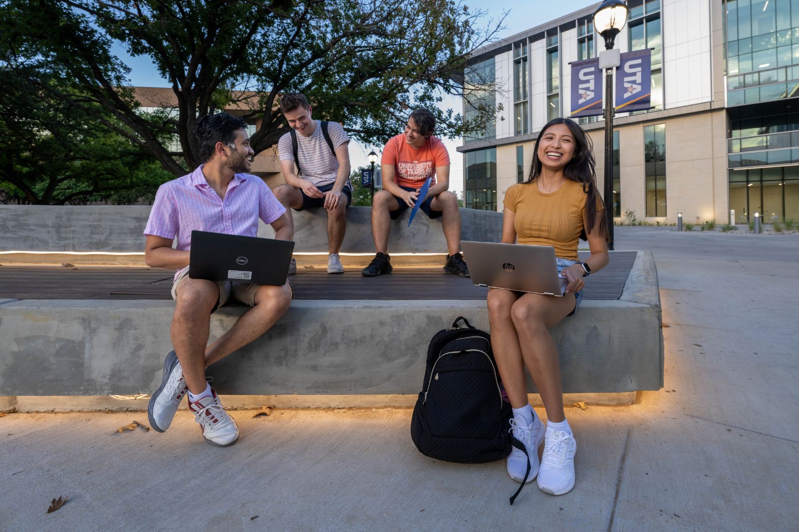 Image shows four UTA students gathered in a study group 
