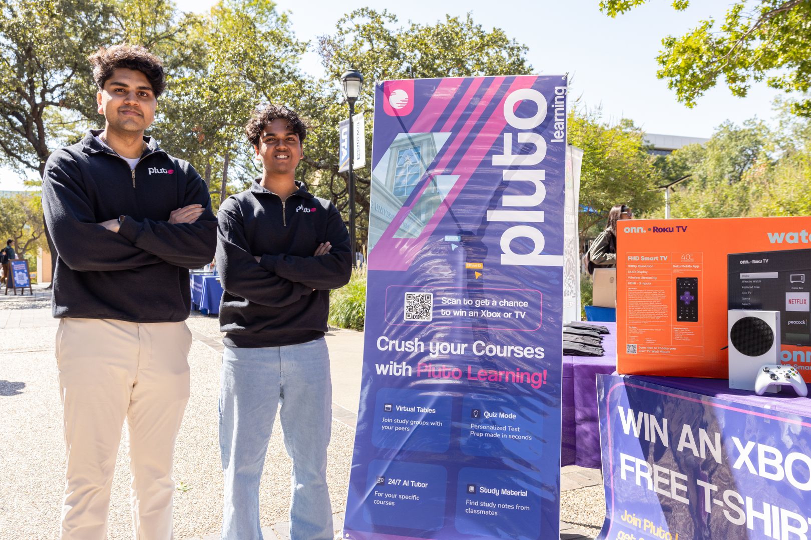 Image shows Ethan Debnath and Sami Ali posing at a tabling event outside the Central Library mall