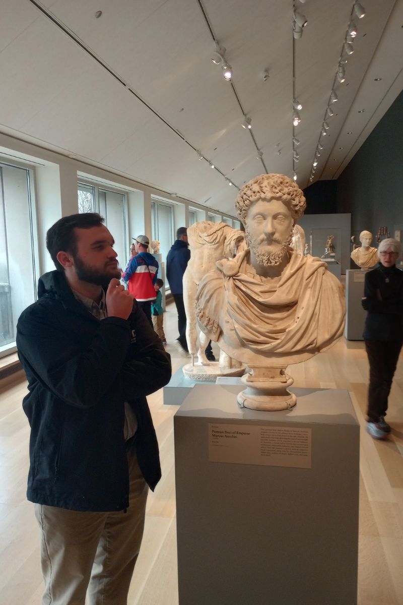 Ben Gervasi next to bust of Marcus Aurelius" src="https://cdn.prod.web.uta.edu/-/media/project/website/news/releases/2025/05/ben-gervasi-4.jpg?la=en" _languageinserted="true