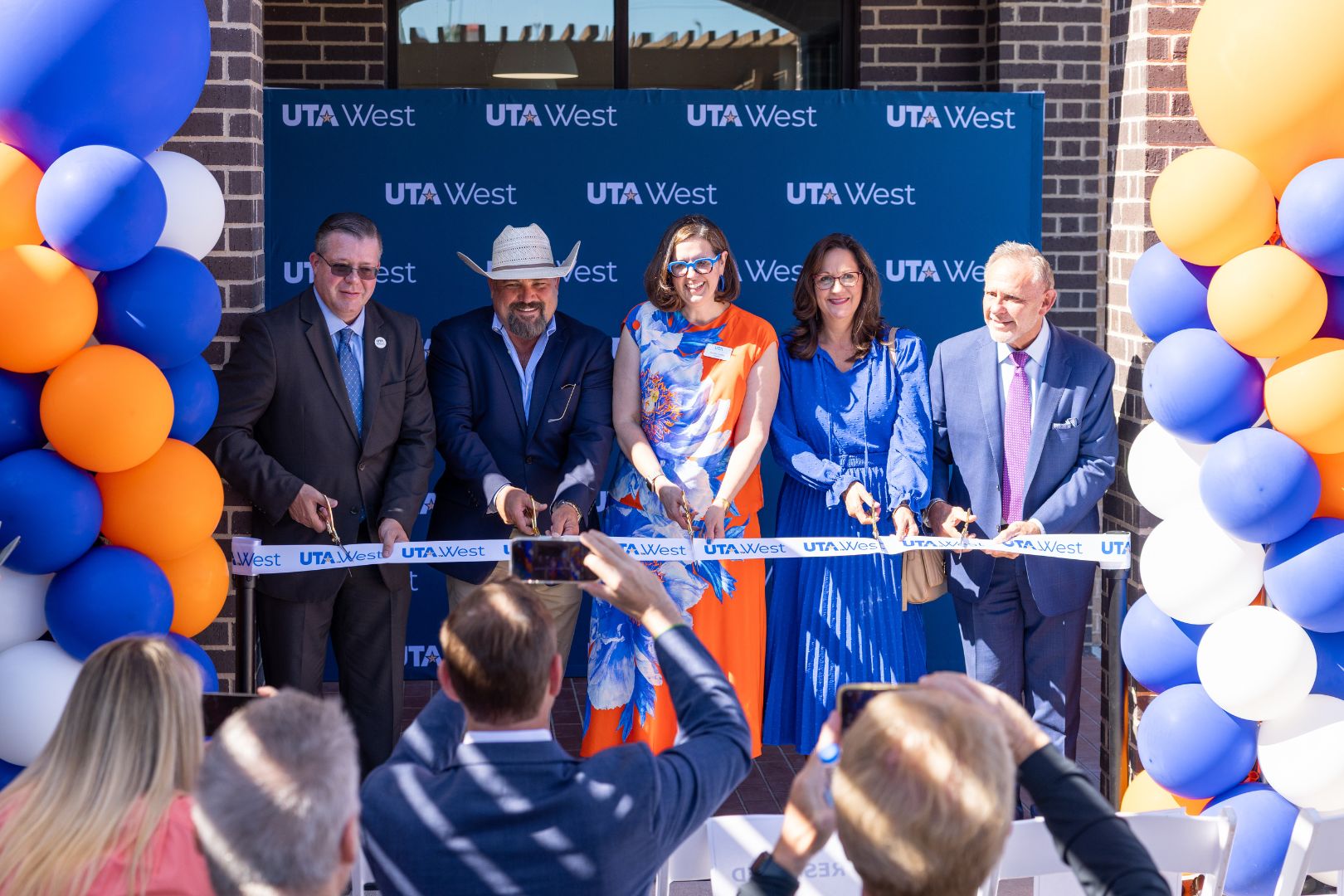 Image shows UTA and Parker County leadership cut the ceremonial ribbon at the new UTA West storefront in Willow Park 