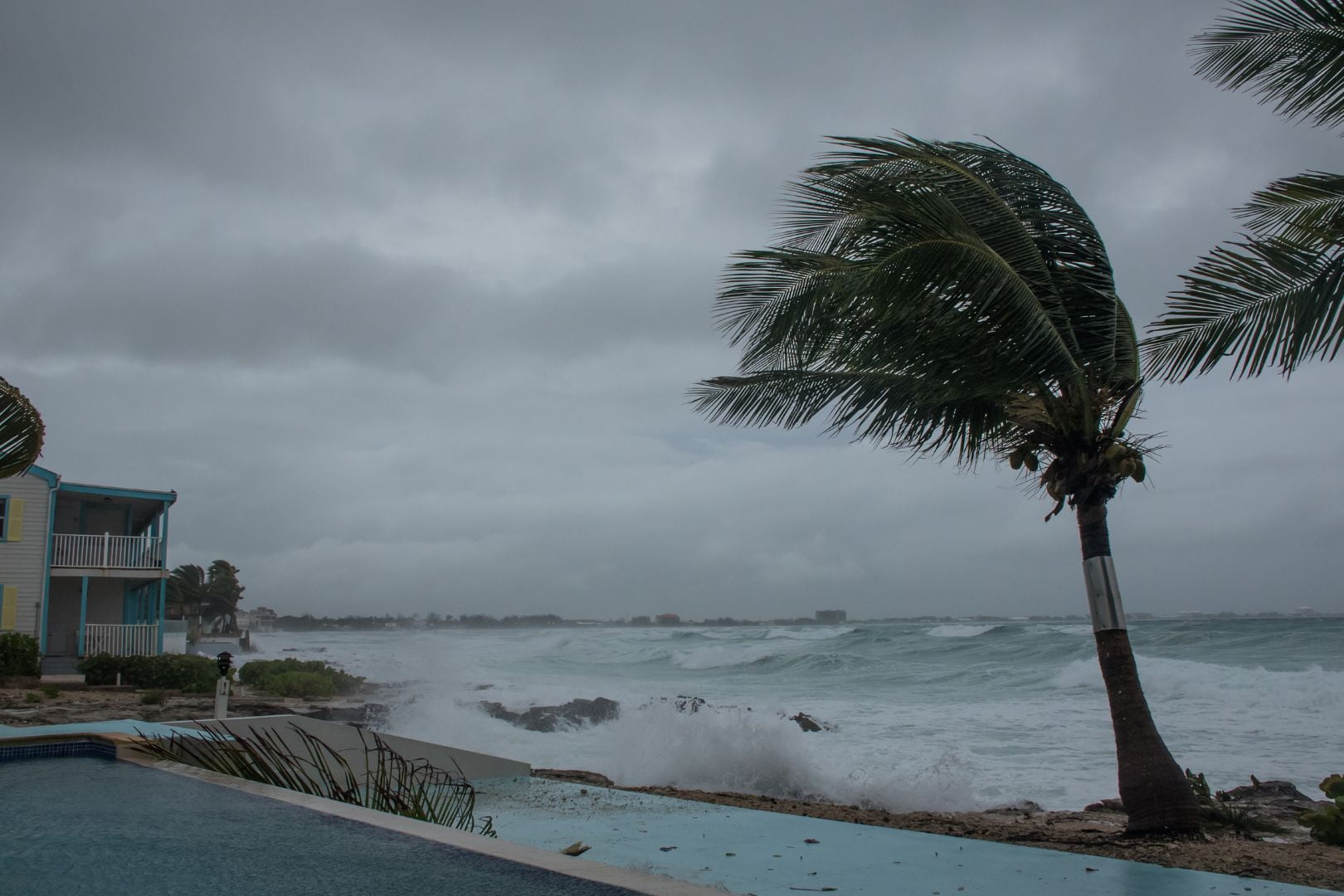 Image shows a stock photo of a hurricane beginning to hit a coast