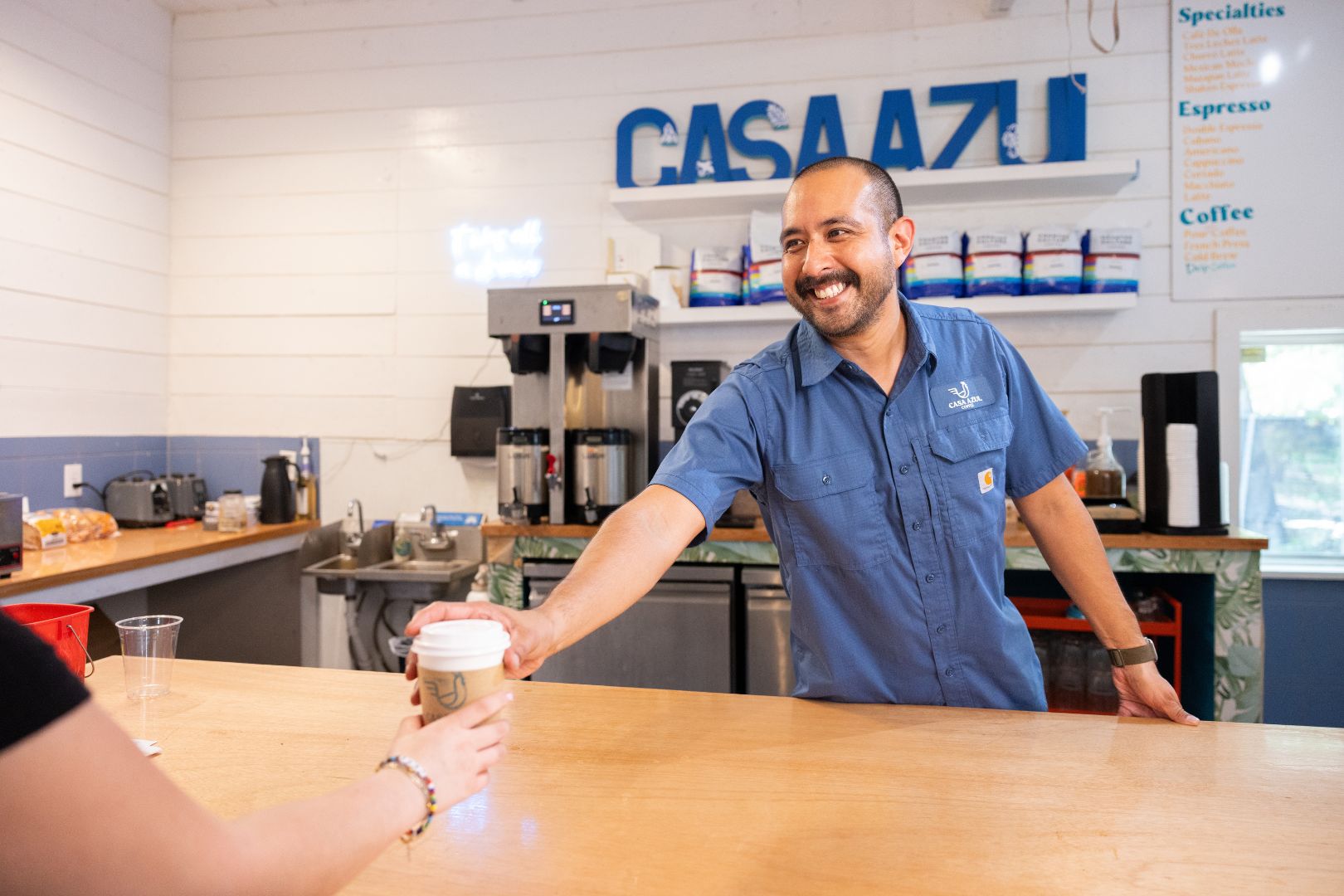 Image shows Joseph Landeros serving coffee at Casa Azul " style=" height:1080px; width:1620px" _languageinserted="true" src="https://cdn.prod.web.uta.edu/-/media/project/website/news/releases/2025/09/casa-azul-inside-1.jpg