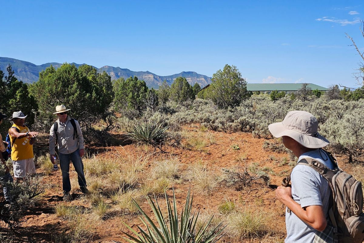 Three students surveying land at the Hawkins Preserve in Cortez, Colorado