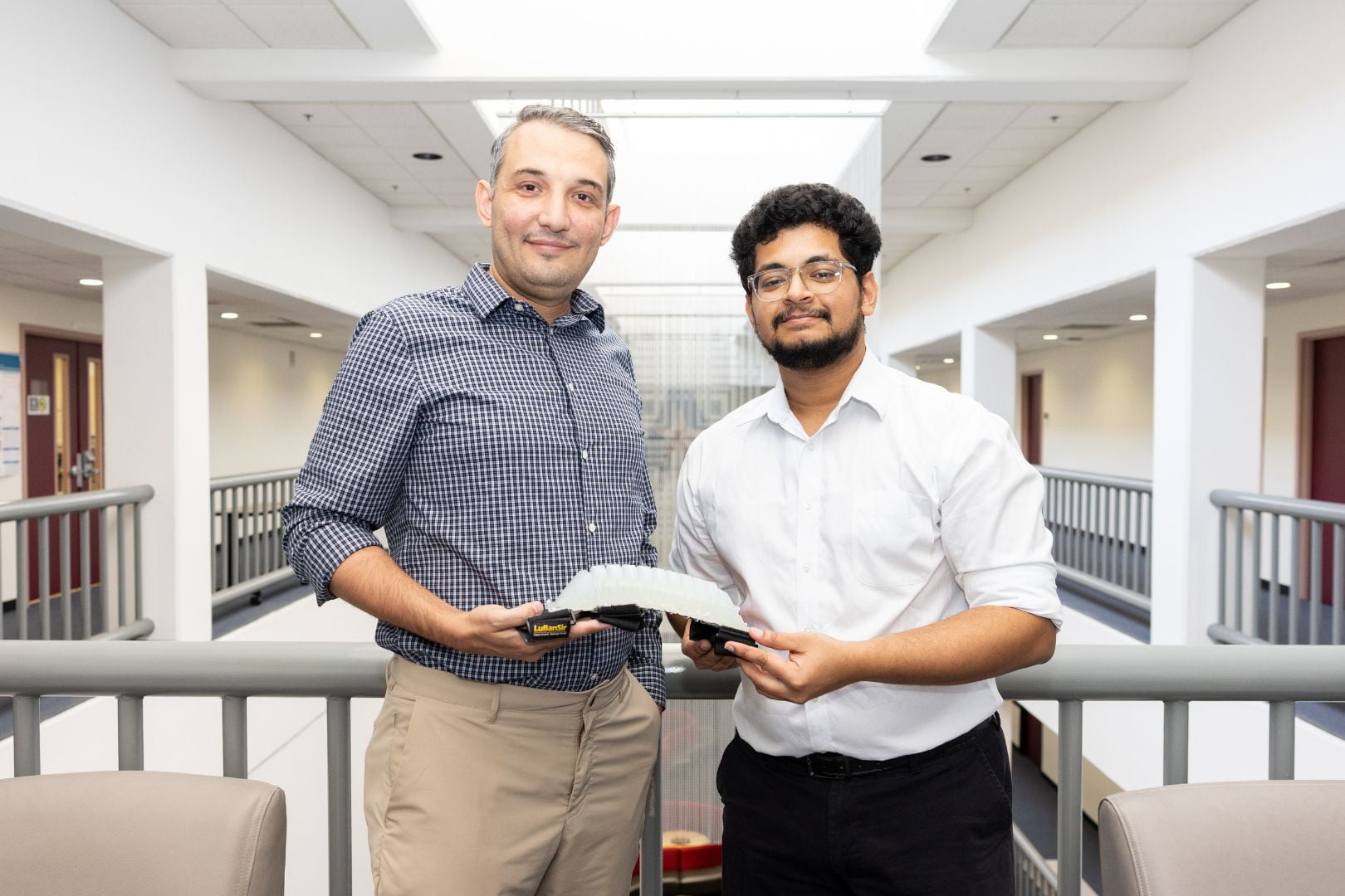 Image shows UTA researchers with their exoskeleton brace
