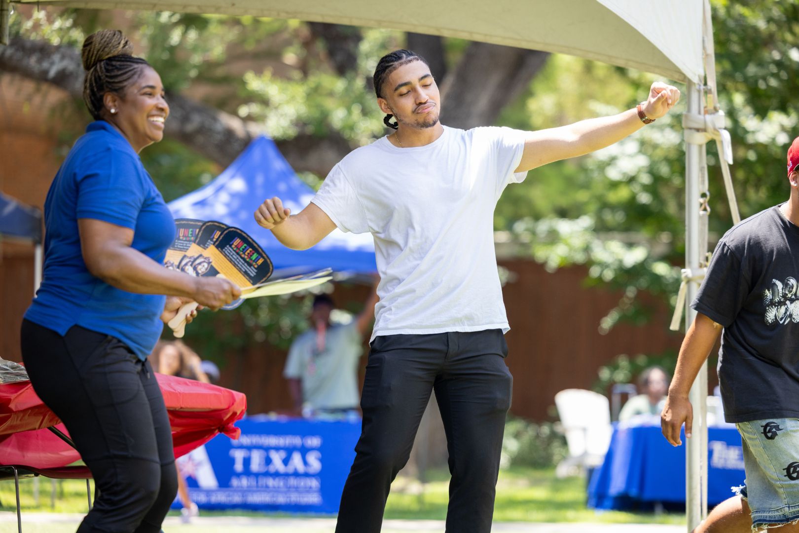 Image shows people dancing at UTA's Juneteenth celebration 