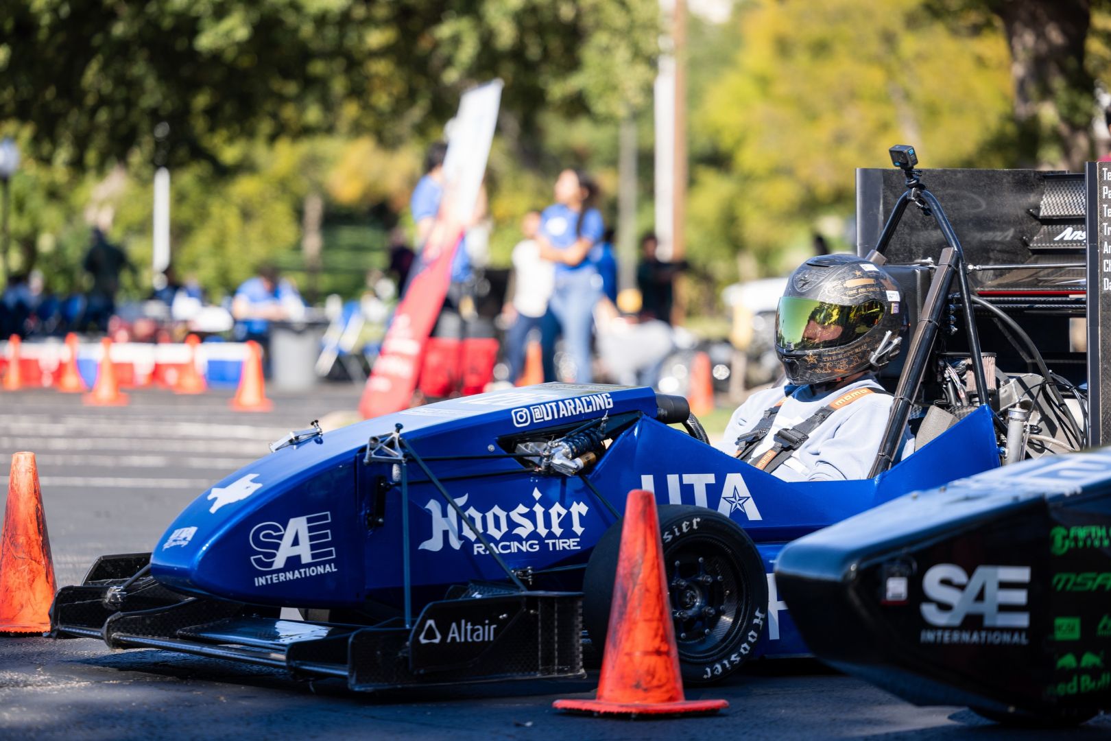 Image shows a UTA Racing formula car in line right before racing off