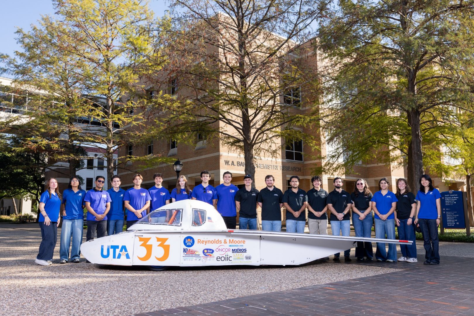 Image shows the UTA Blaze Raycers team posing with the solar car