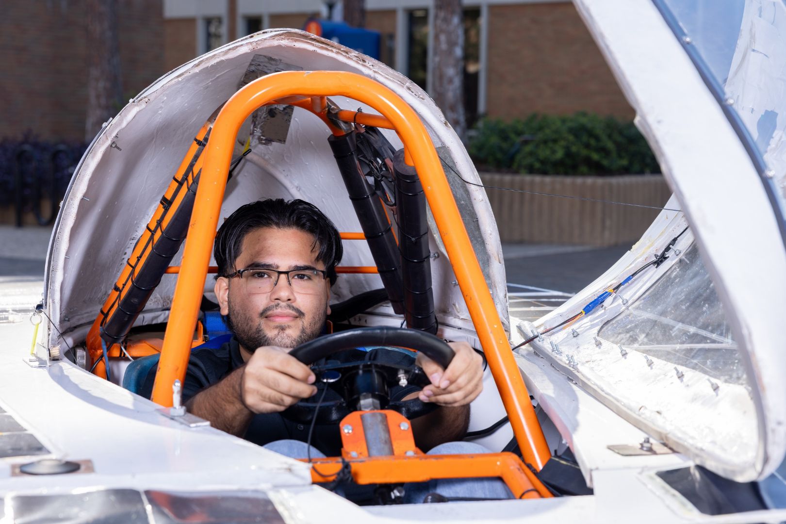 Image shows UTA Blaze Raycers team member inside the solar car