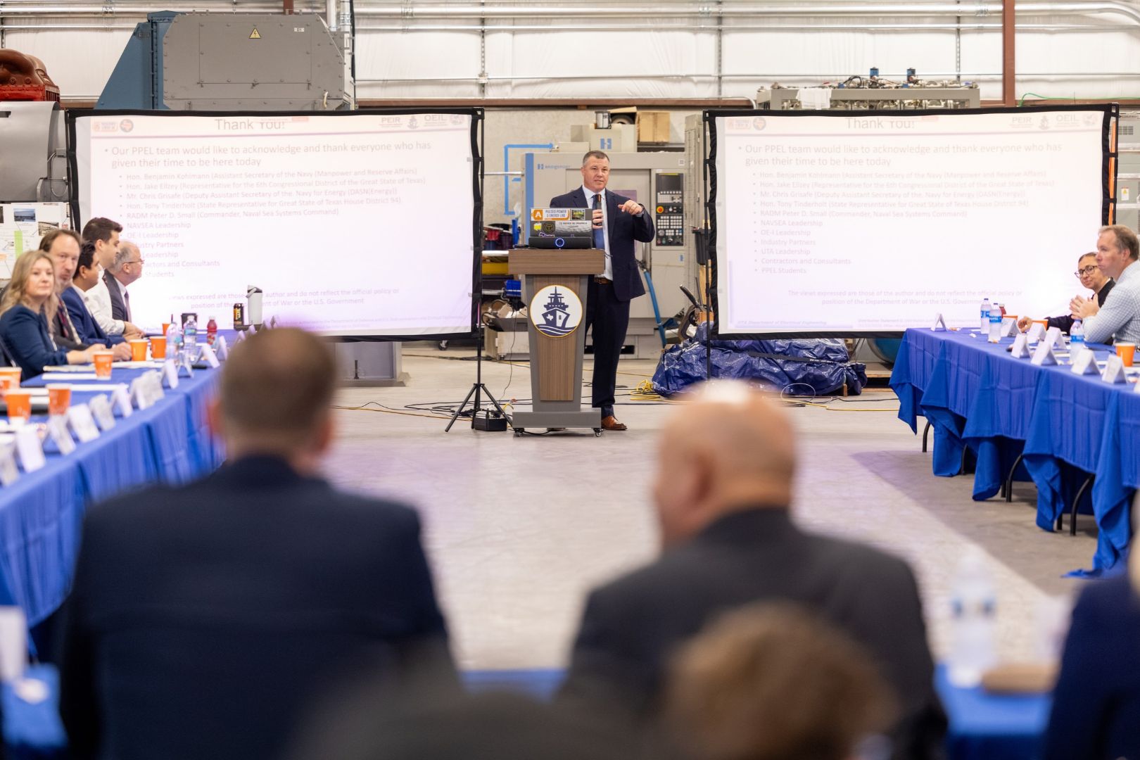 Image shows Dr. David Wetz speaking to a room full of U.S. Navy leaders and officials