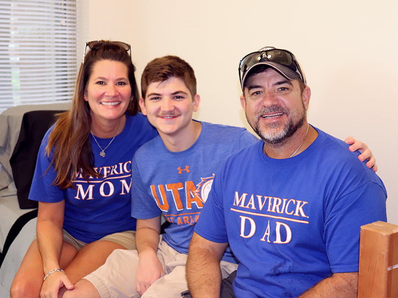 Parents and son wearing UTA spirit shirts