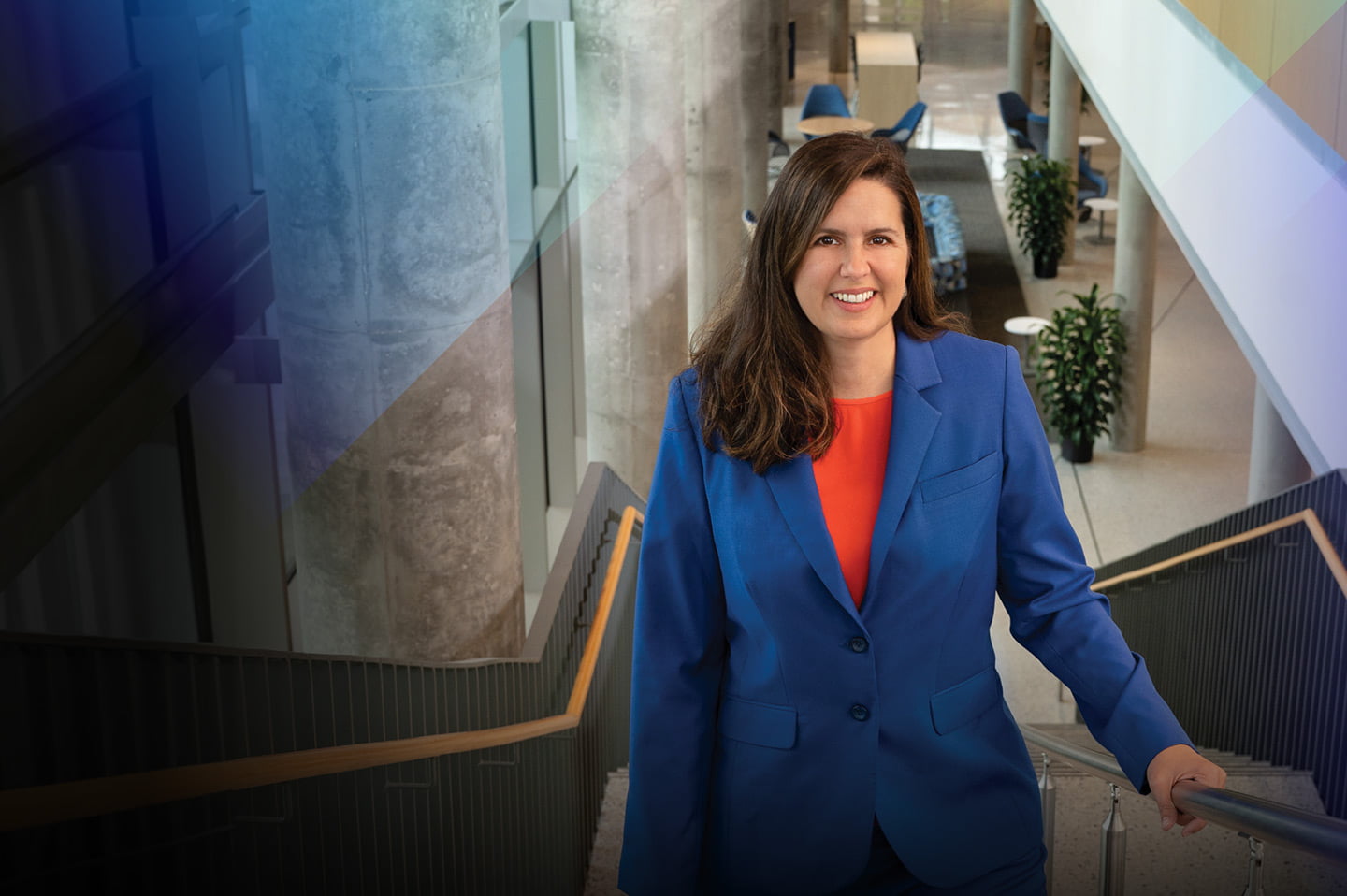 president cowley smiling on the stairs inside uta building