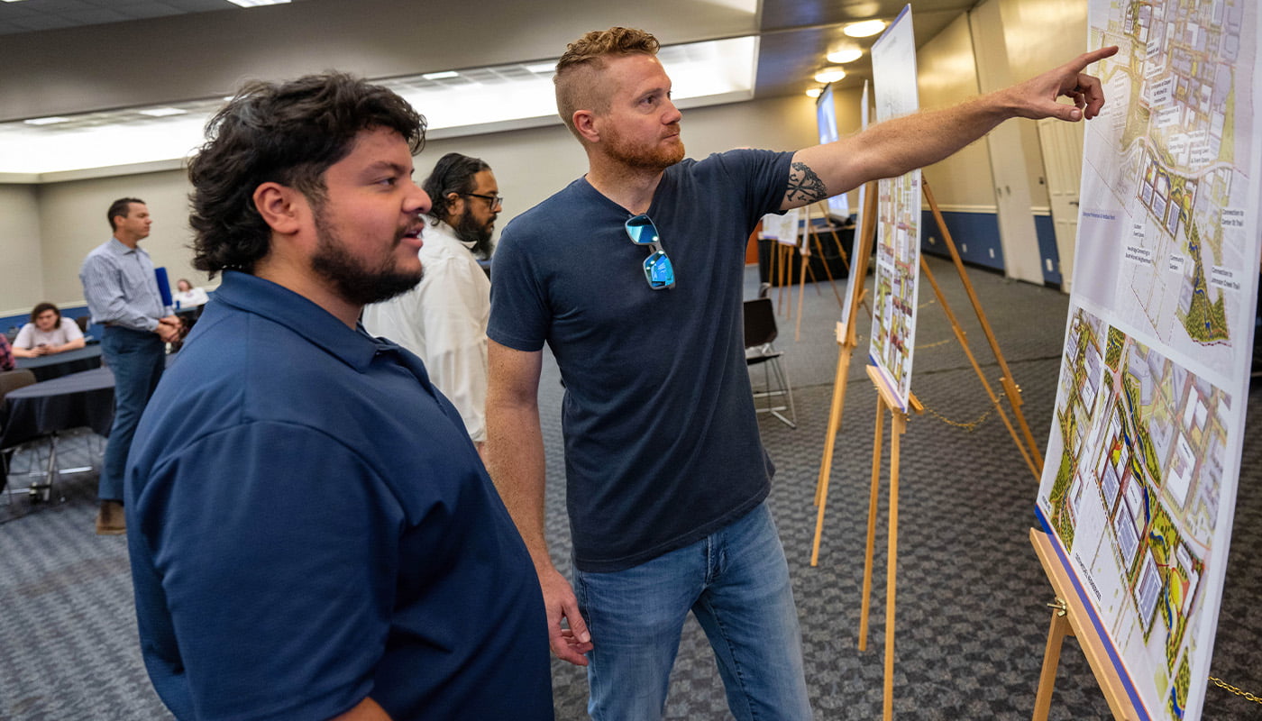 two men looking at an easel