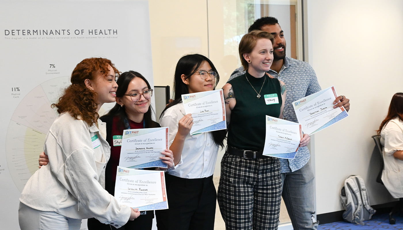 a group of five students holding certificates of excellence pose for a photo