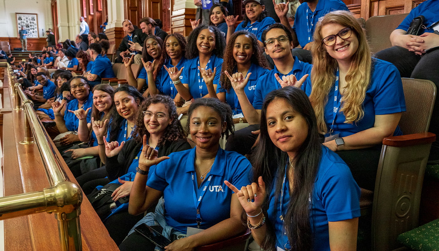a group of students sitting in the gallery of the texas capitol